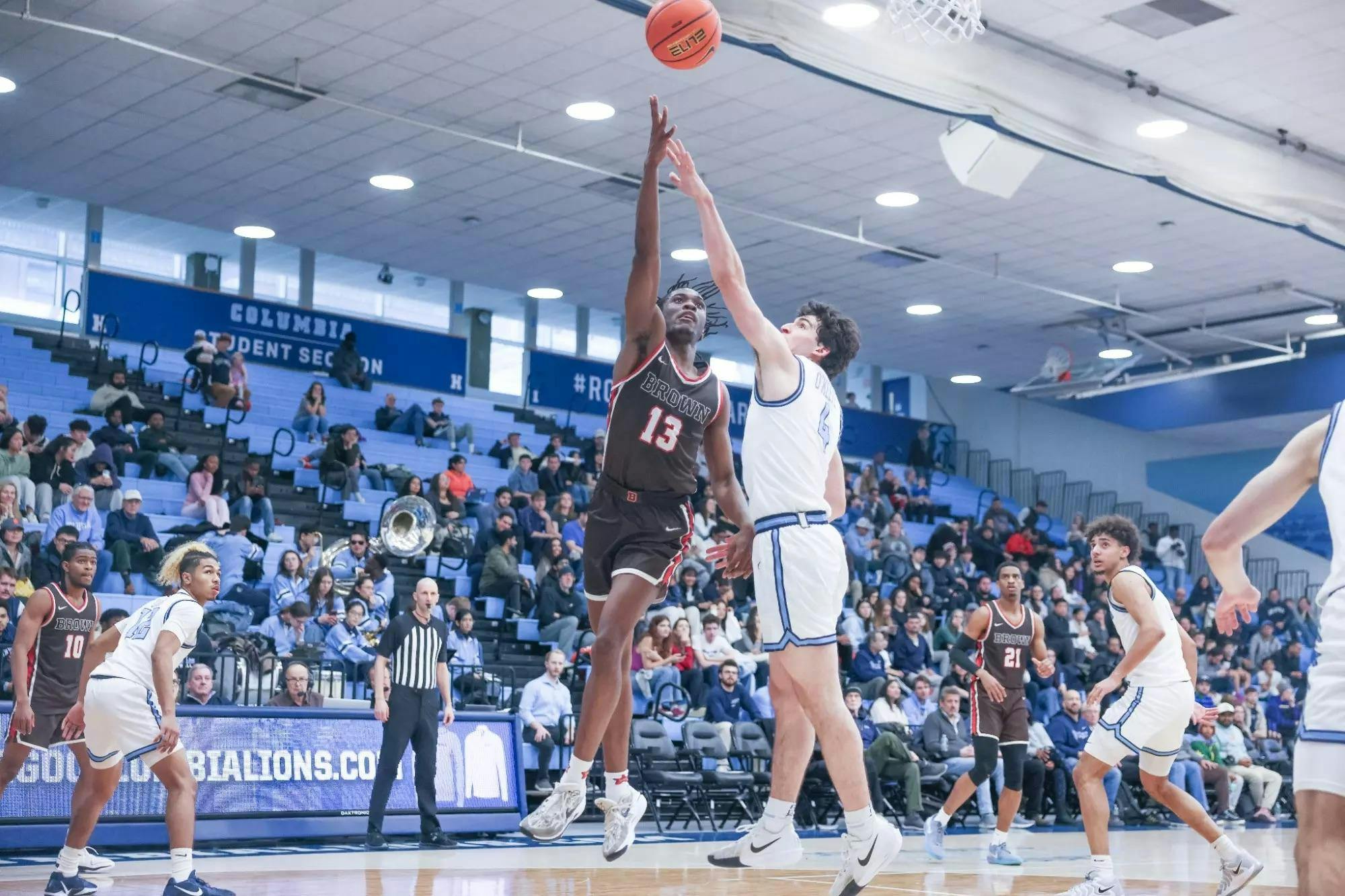 Malcolm Wrisby-Jefferson is mid-air on a layup as a Columbia defender attempts to block him.