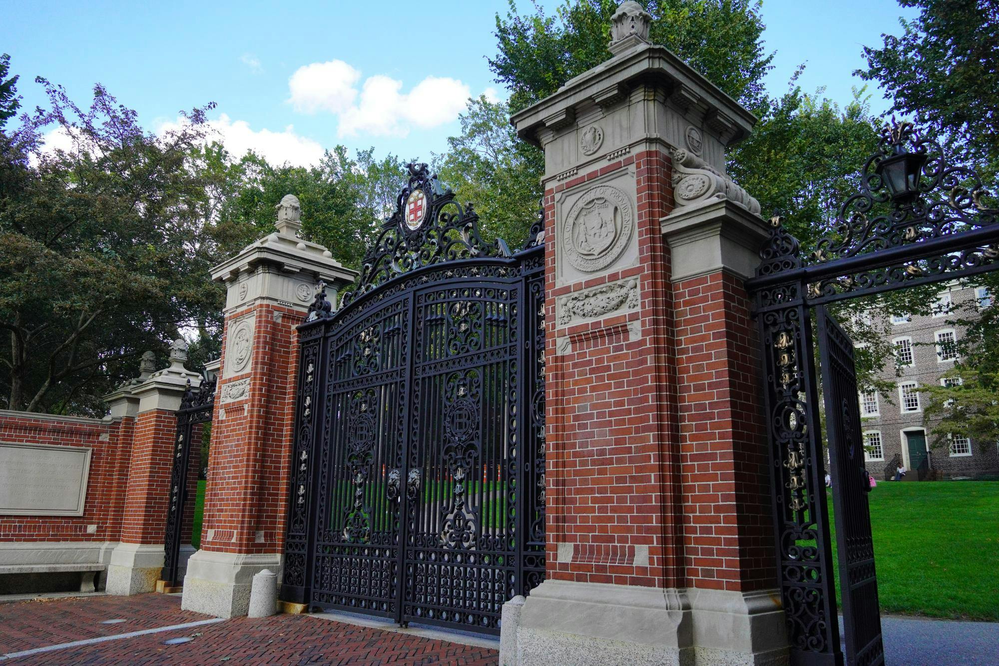 Photo of Van Wickle Gates with University Hall in the background.