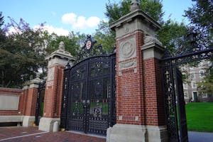 Photo of Van Wickle Gates with University Hall in the background.