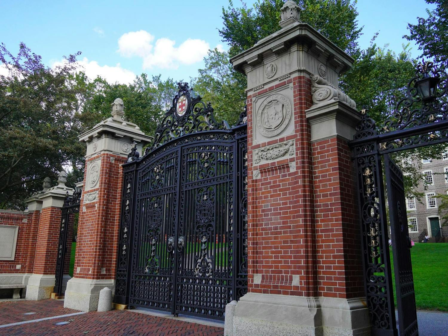 Photo of Van Wickle Gates with University Hall in the background.