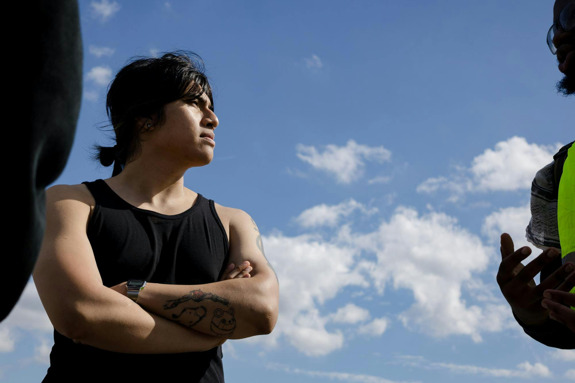 Photo of Axel Brito talking to someone viewed from below.