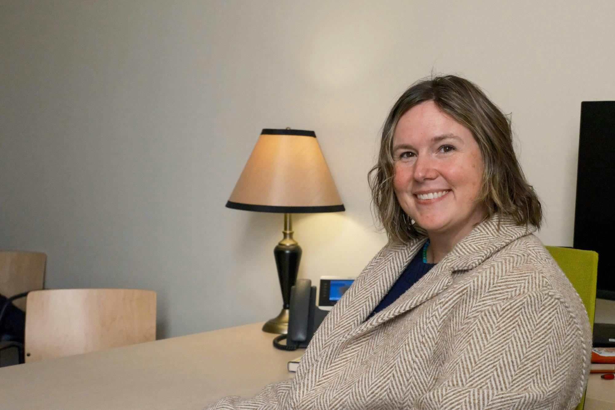 Headshot of Director of Student Accessibility Services Erin Williams Benson smiling at the camera.