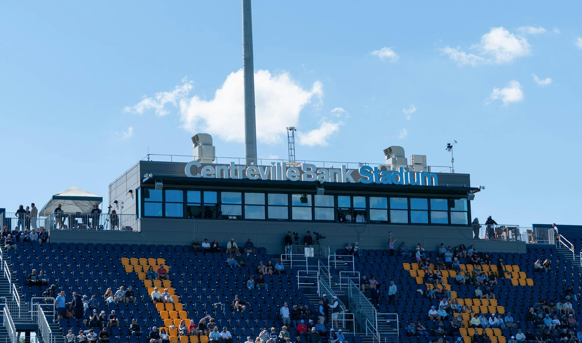 A photo of two seated sections in Centreville Bank Stadium against a relatively clear, blue sky. The seats are navy blue. A photo of two seated sections in Centreville Bank Stadium against a relatively clear, blue sky. The seats are navy blue.
