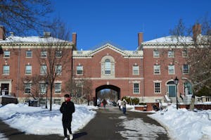 Faunce Arch, a brick building, on a snowy day.