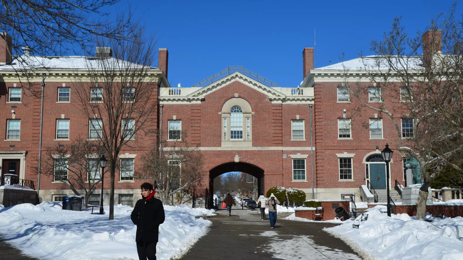 Faunce Arch, a brick building, on a snowy day.