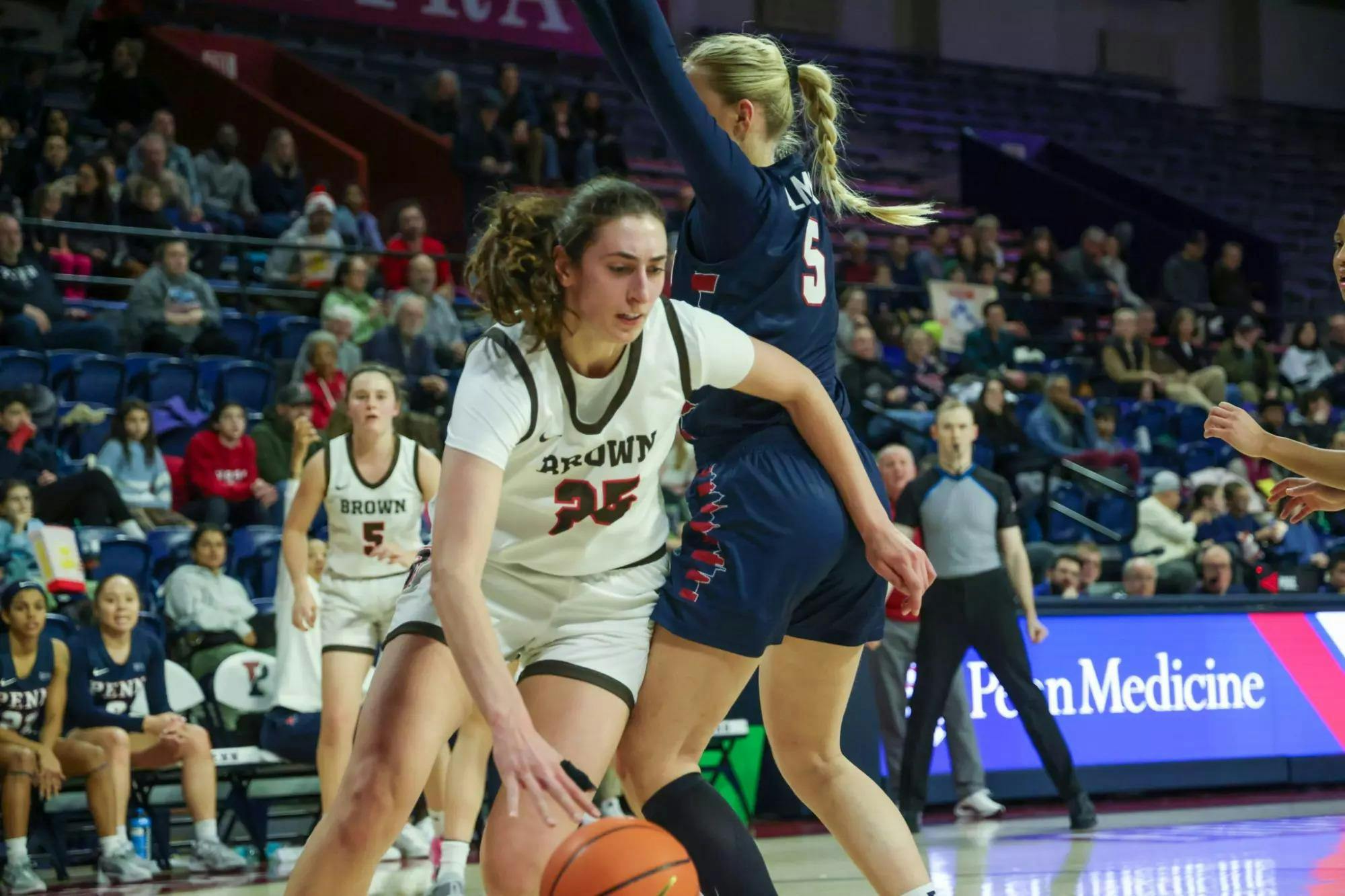 Gianna Aiello '25 drives the lane under a UPenn player.