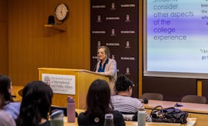 DeLuca speaking at a podium in front of a room of students.