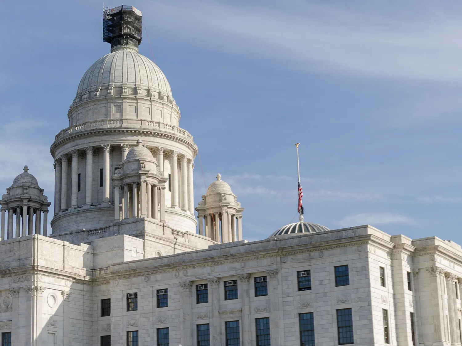 A photo of the Rhode Island state house, with the white domed building against a sunny blue sky.