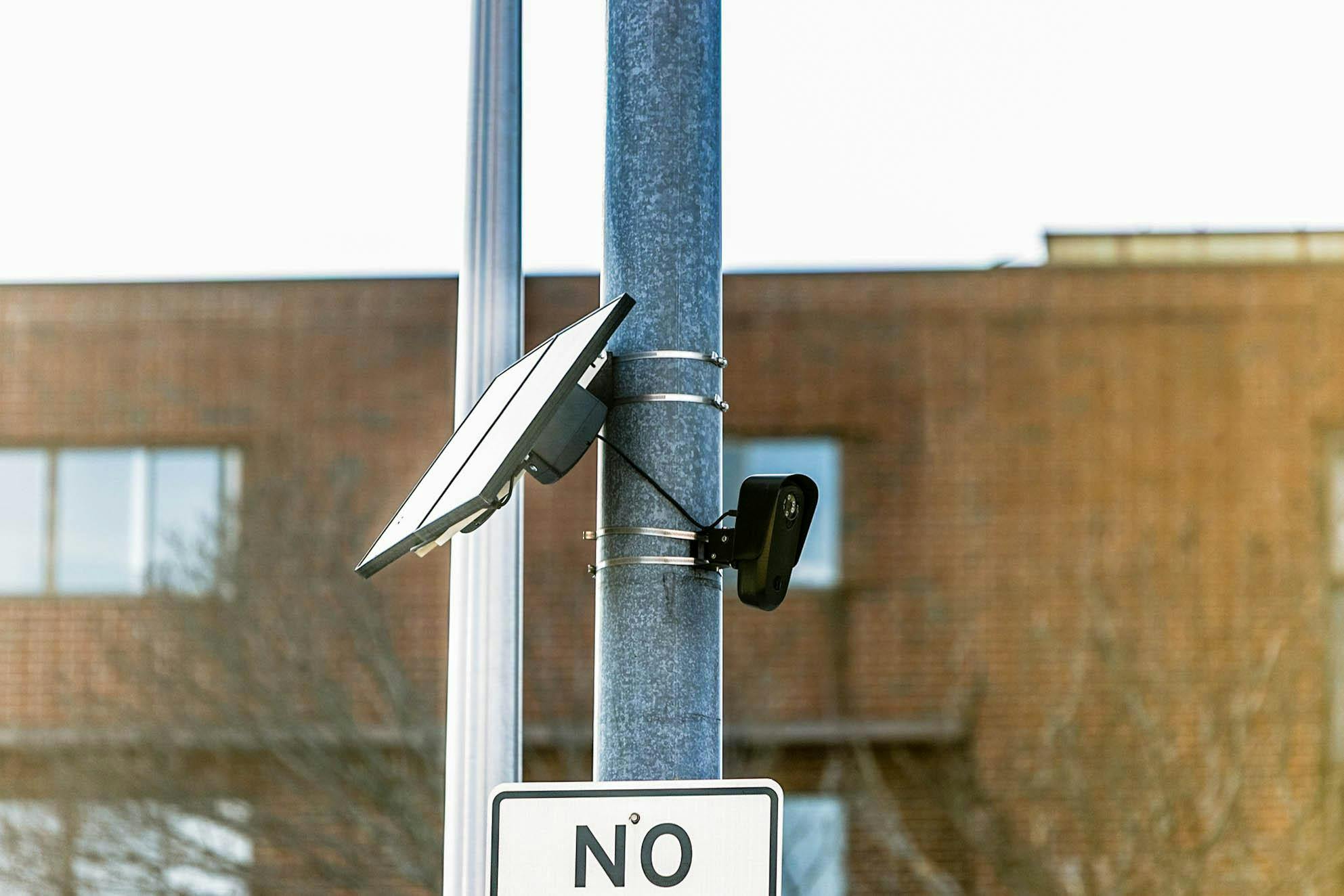 A black Flock camera is attached to an electrical pole in Providence. 