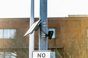 A black Flock camera is attached to an electrical pole in Providence. 