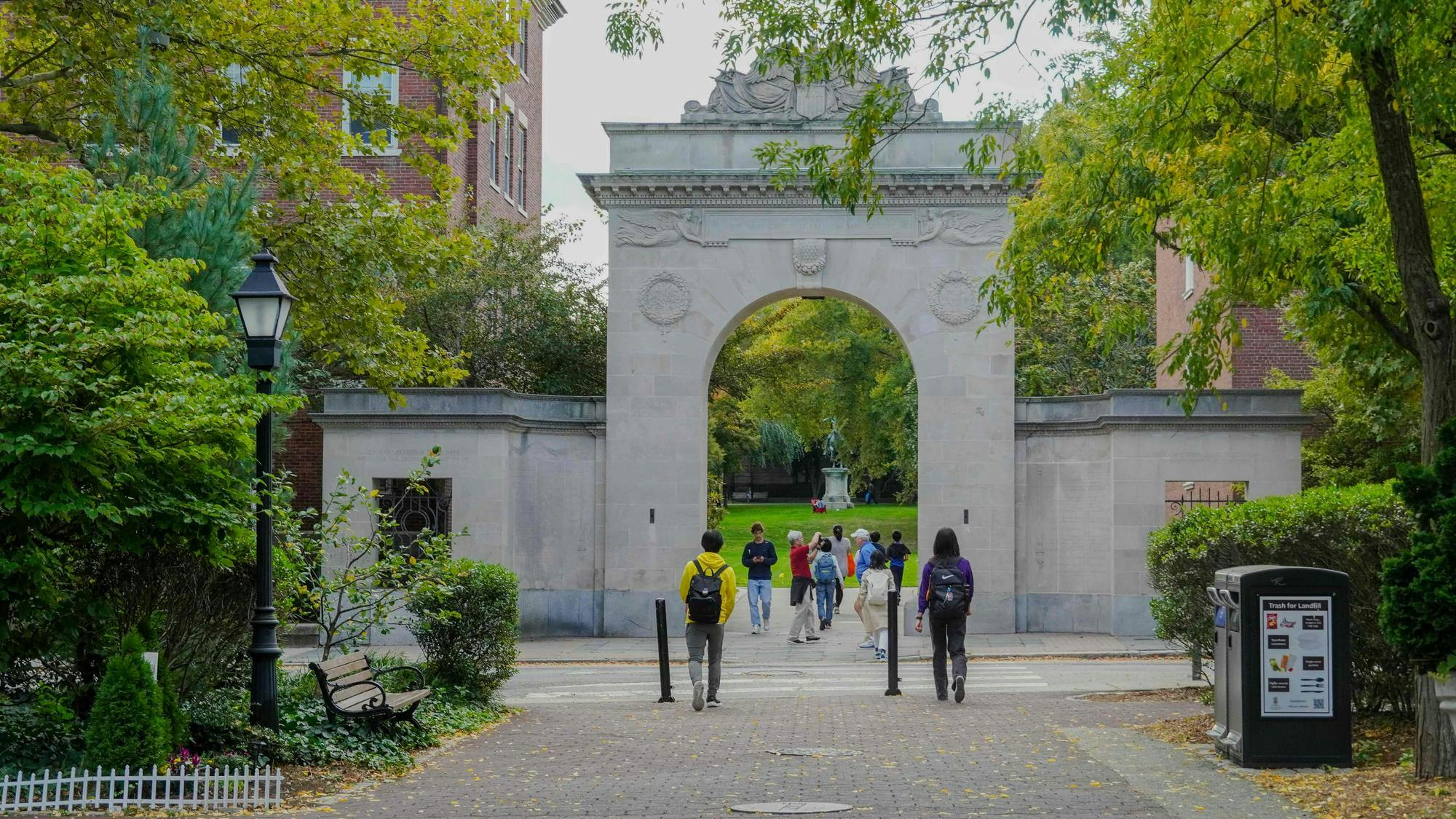 Photo of the Soldiers' Arch with green trees surrounding it and students walking through it