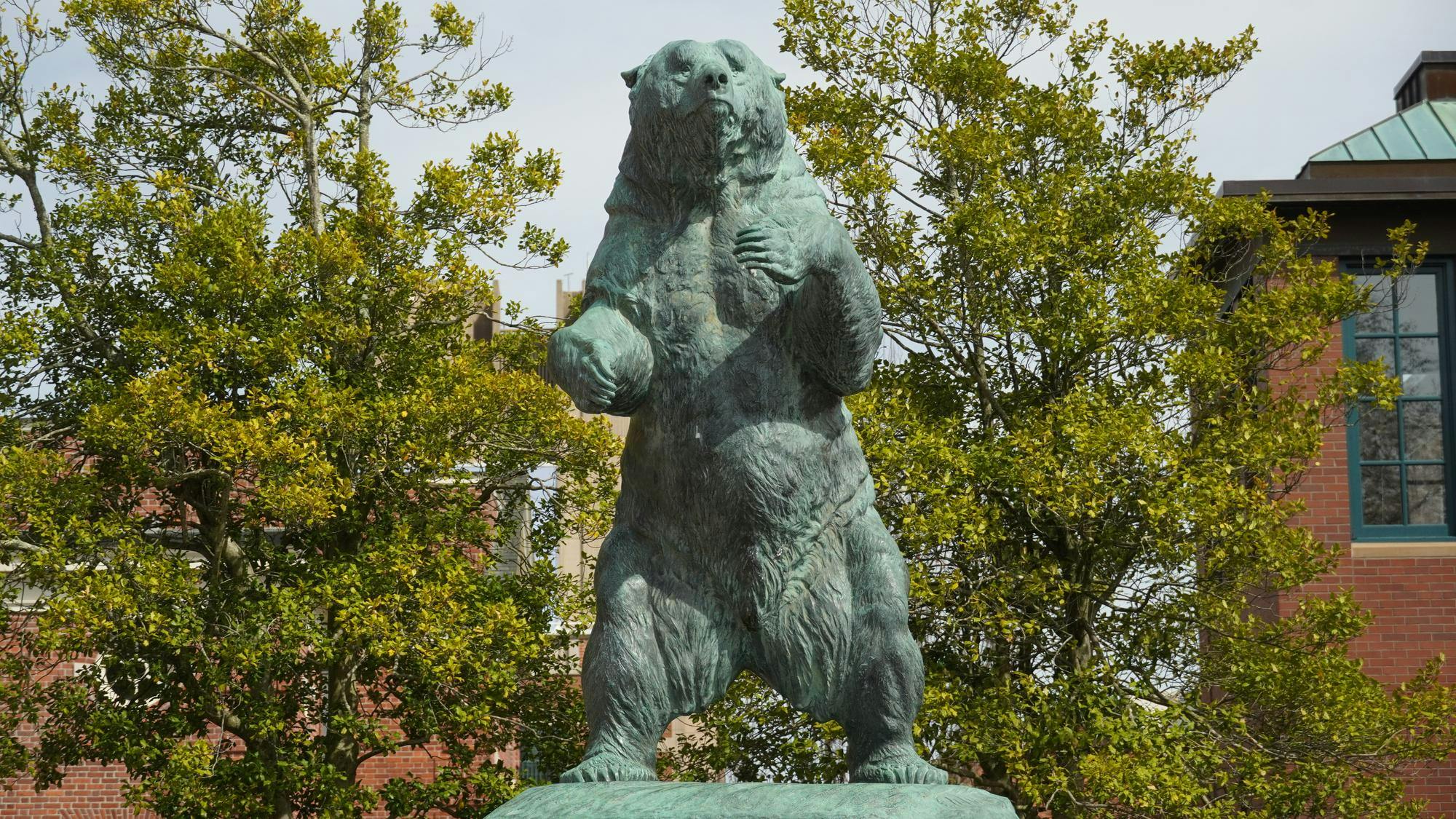 A photo of the green bear statue on Brown's Main Green on a sunny day. 