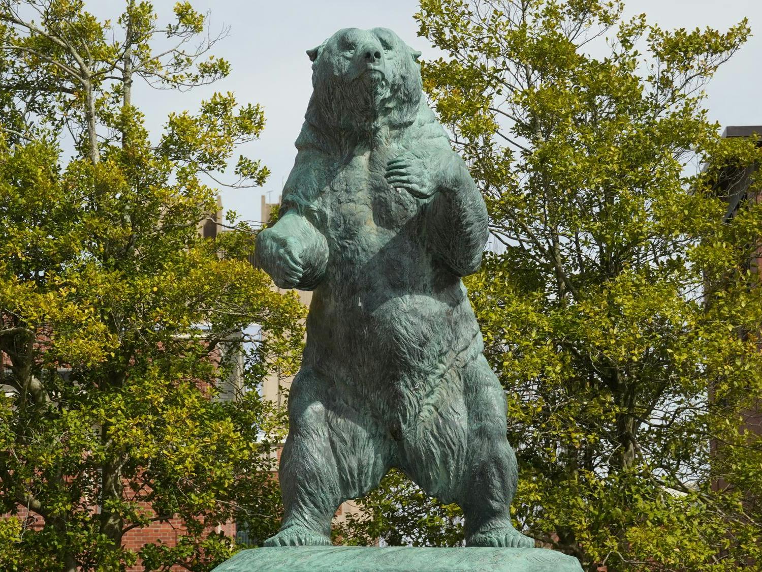 A photo of the green bear statue on Brown's Main Green on a sunny day.