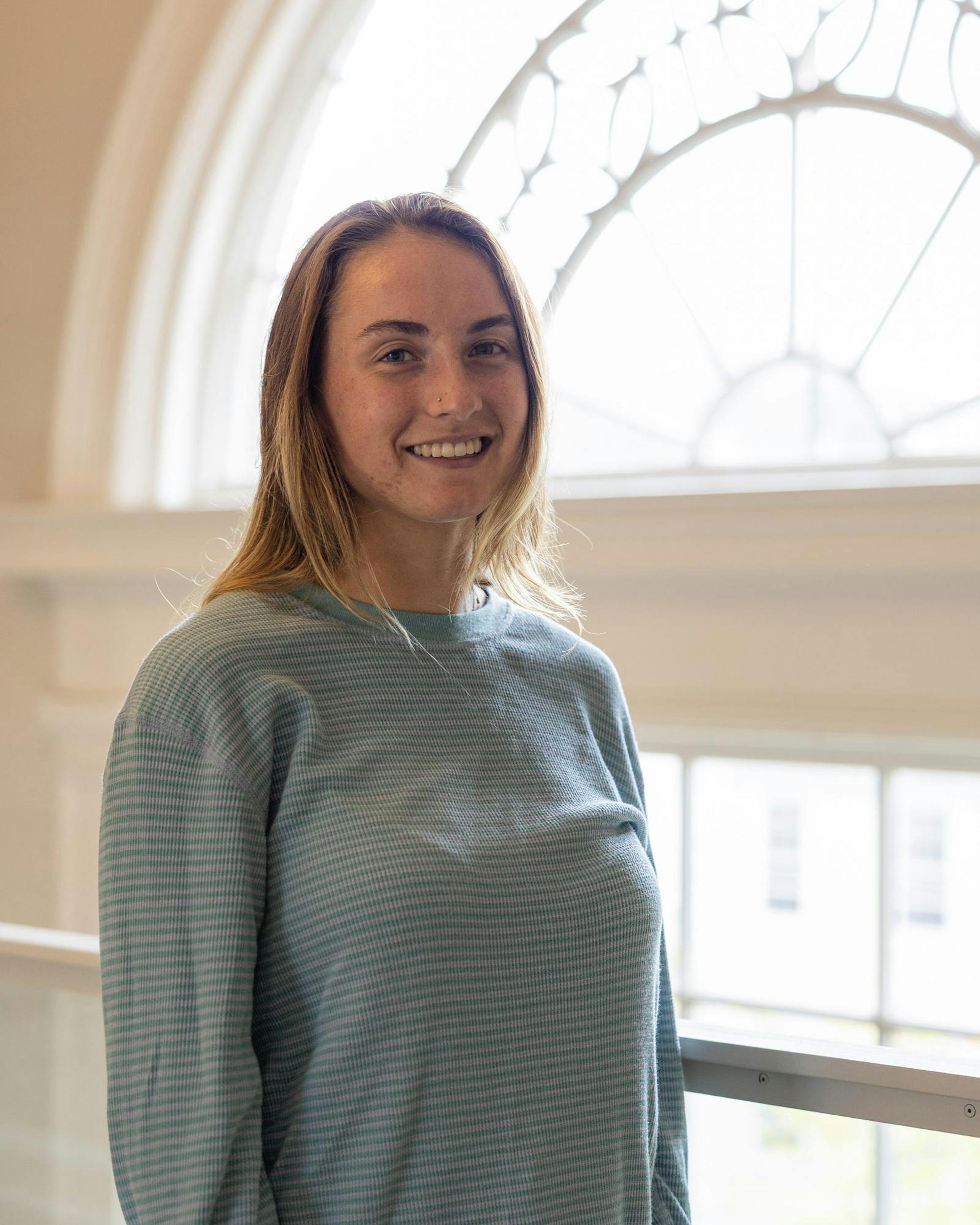 Image of Julie standing in front of the window.