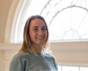 Image of Julie standing in front of the window.