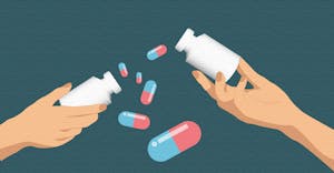 Two hands holding pill bottles and some pills flying around.