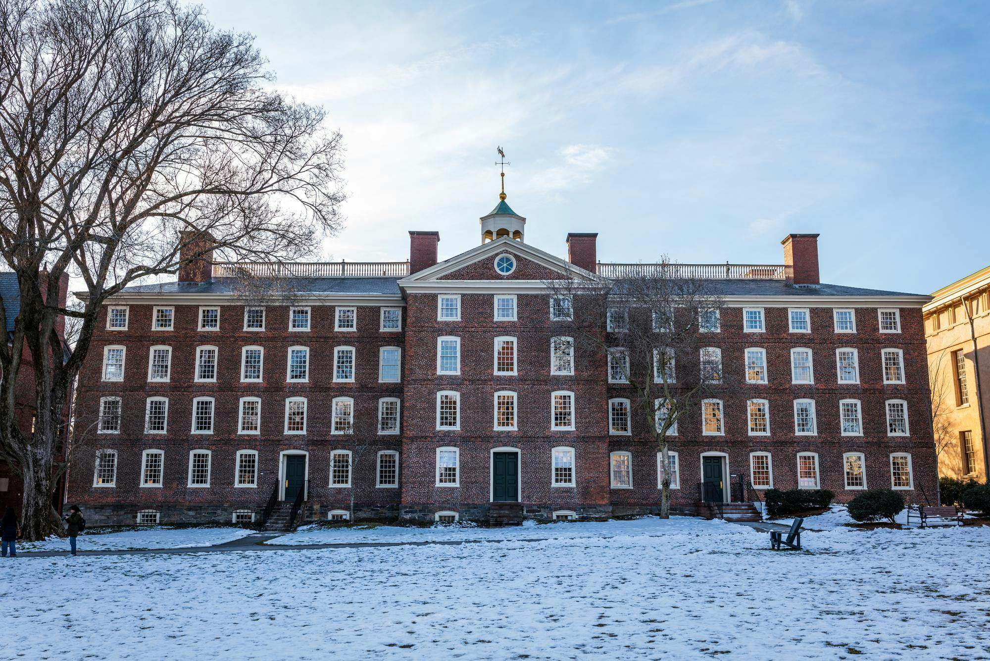 Photo of University Hall with a snowy lawn in front.

