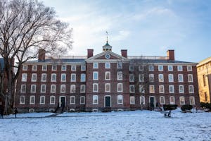 Photo of University Hall with a snowy lawn in front.

