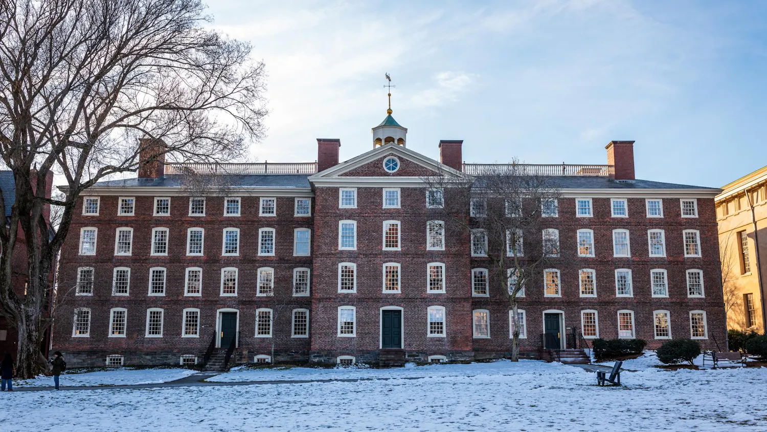 Photo of University Hall with a snowy lawn in front.