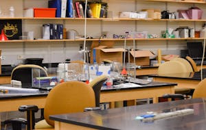 Equipment for a physics laboratory sits on a table in a Barus and Holley classroom.