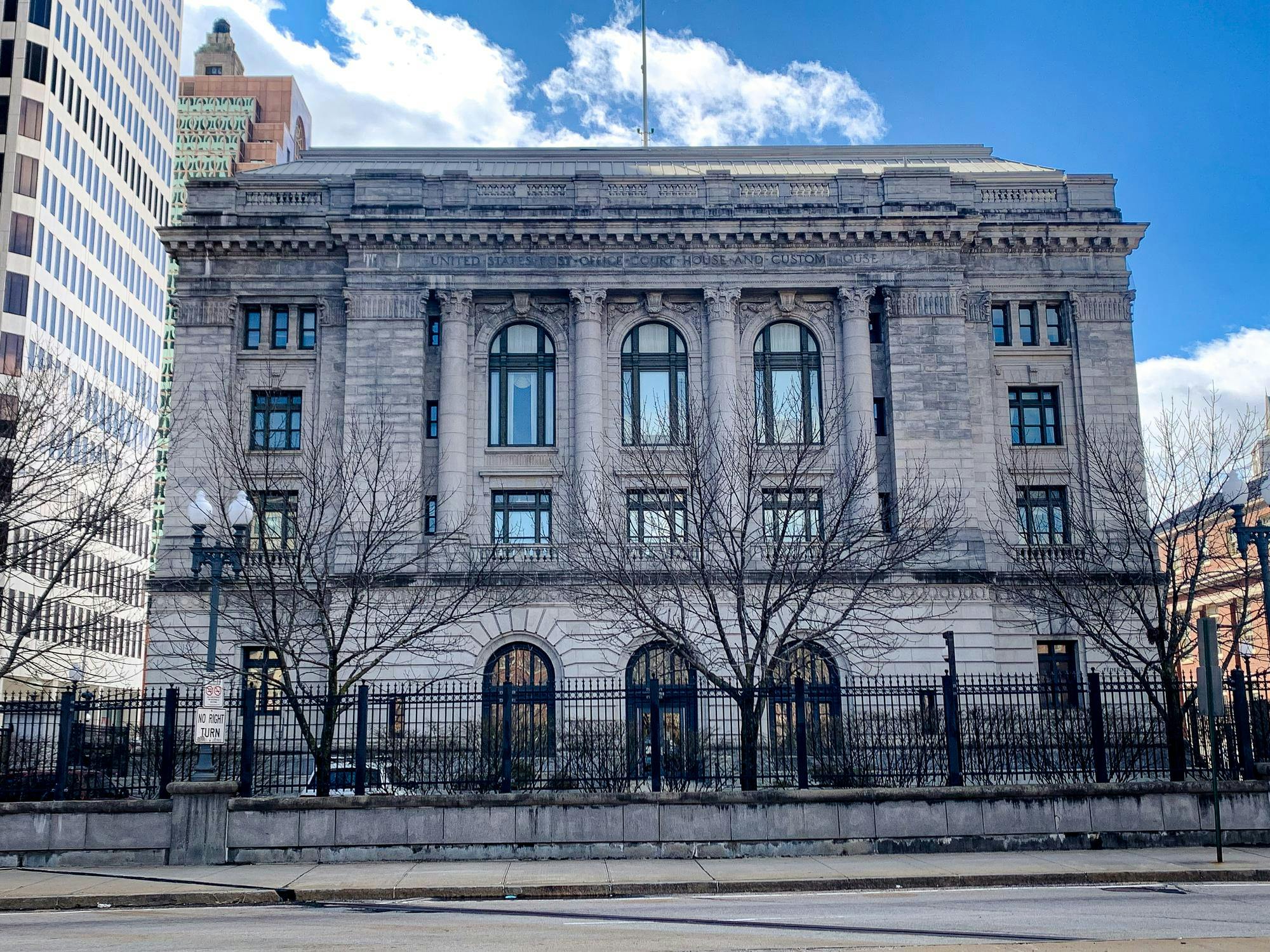 A photo of the Providence federal building and courthouse with bare trees in front.