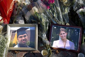 Photo of two framed photos atop bouquets of flowers. In the photo on the left is Mukhammad Aziz Umurzokov ’29, who is smiling and wearing a graduation regalia. In the photo on the right is Ella Cook, also smiling at the camera.