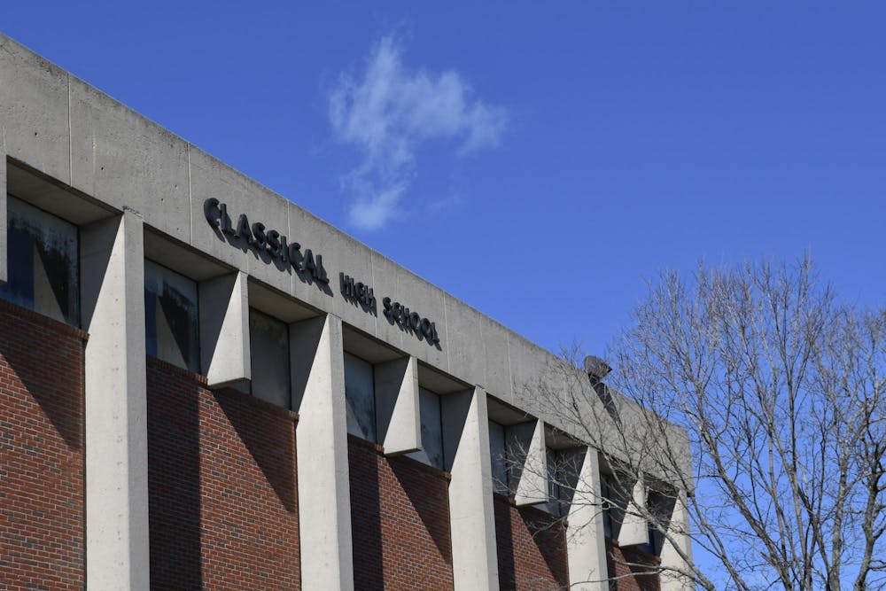 A photo of the outside of Classical High School showing its name labeled on the building on a sunny day. 