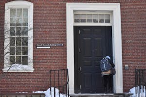 A student entering the Metcalf Research Building on Thayer Street.