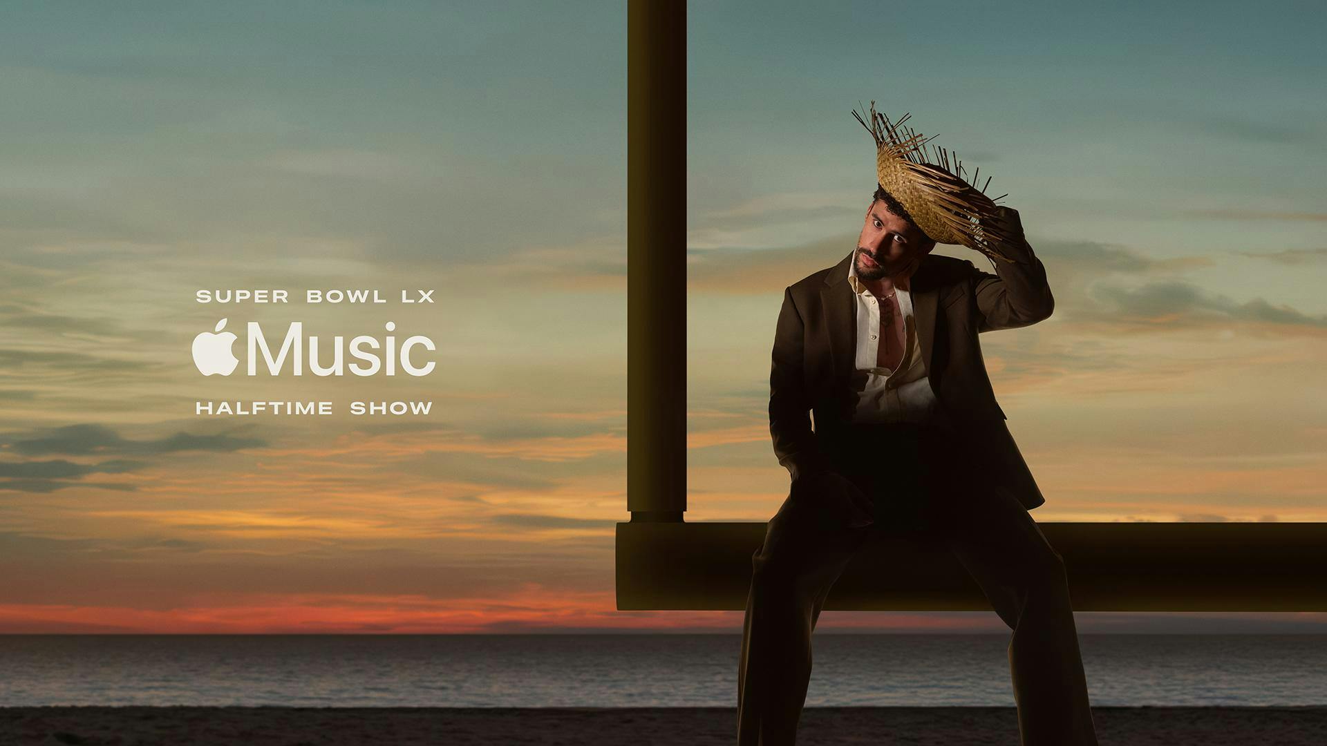 A photo of Bad Bunny, donning a pava and brown suit, sitting atop a football goalpost in front of a sunset on a beach. Over the photo, white text reads "Super Bowl LX" above the Apple Music logo and additional text reading "Halftime show."