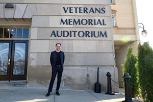 Eric Nathan, wearing a suit and standing outside the Veterans Memorial Auditorium.