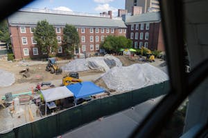 Photo of Ruth Simmons Quadrangle as of Sept. 4, viewed from Lincoln Field Building. Construction is ongoing with equipment, raw material and large mounds of soil on site.