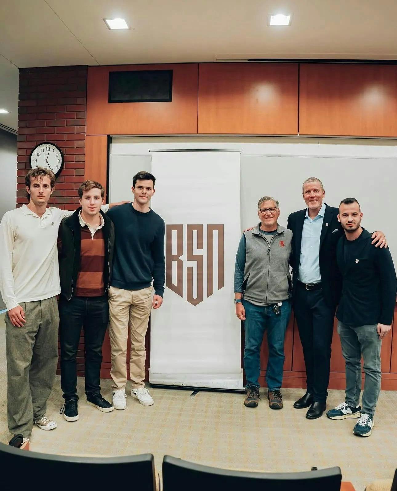 Six men standing in front of a Brown Sports Network banner