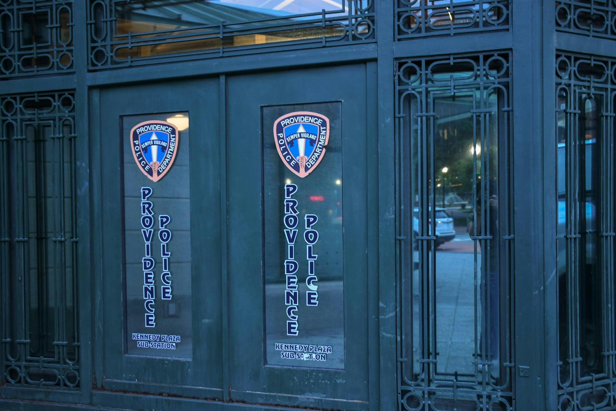 Photo of the Providence Police Department's Kennedy Plaza sub-station, an ornate black door with two police-department logos displayed on windowpanes.