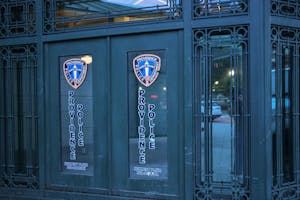 Photo of the Providence Police Department's Kennedy Plaza sub-station, an ornate black door with two police-department logos displayed on windowpanes.