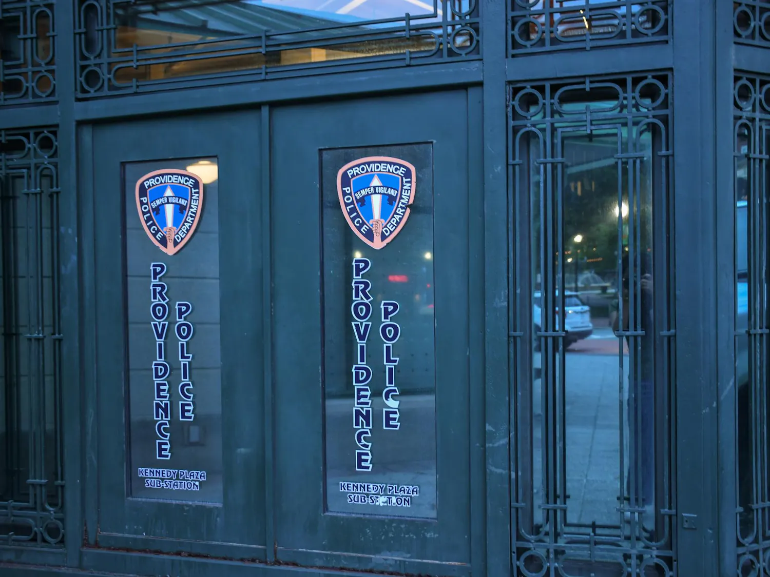 Photo of the Providence Police Department's Kennedy Plaza sub-station, an ornate black door with two police-department logos displayed on windowpanes.