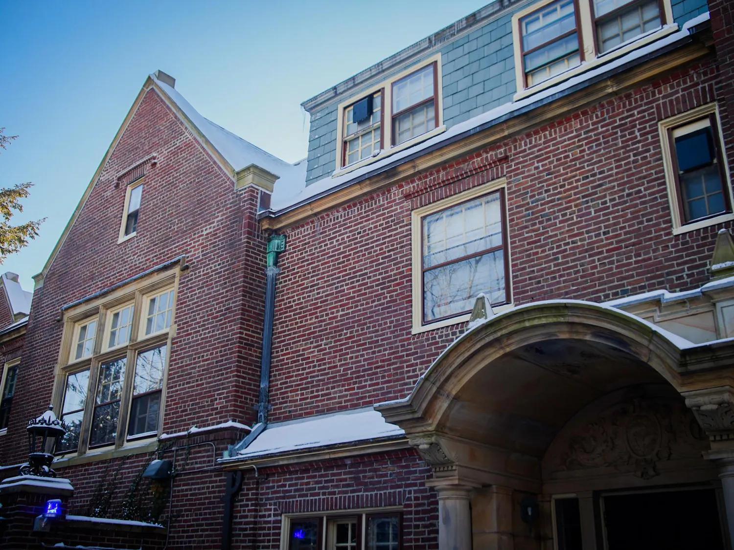 A red-brick building with a snow-covered roof.