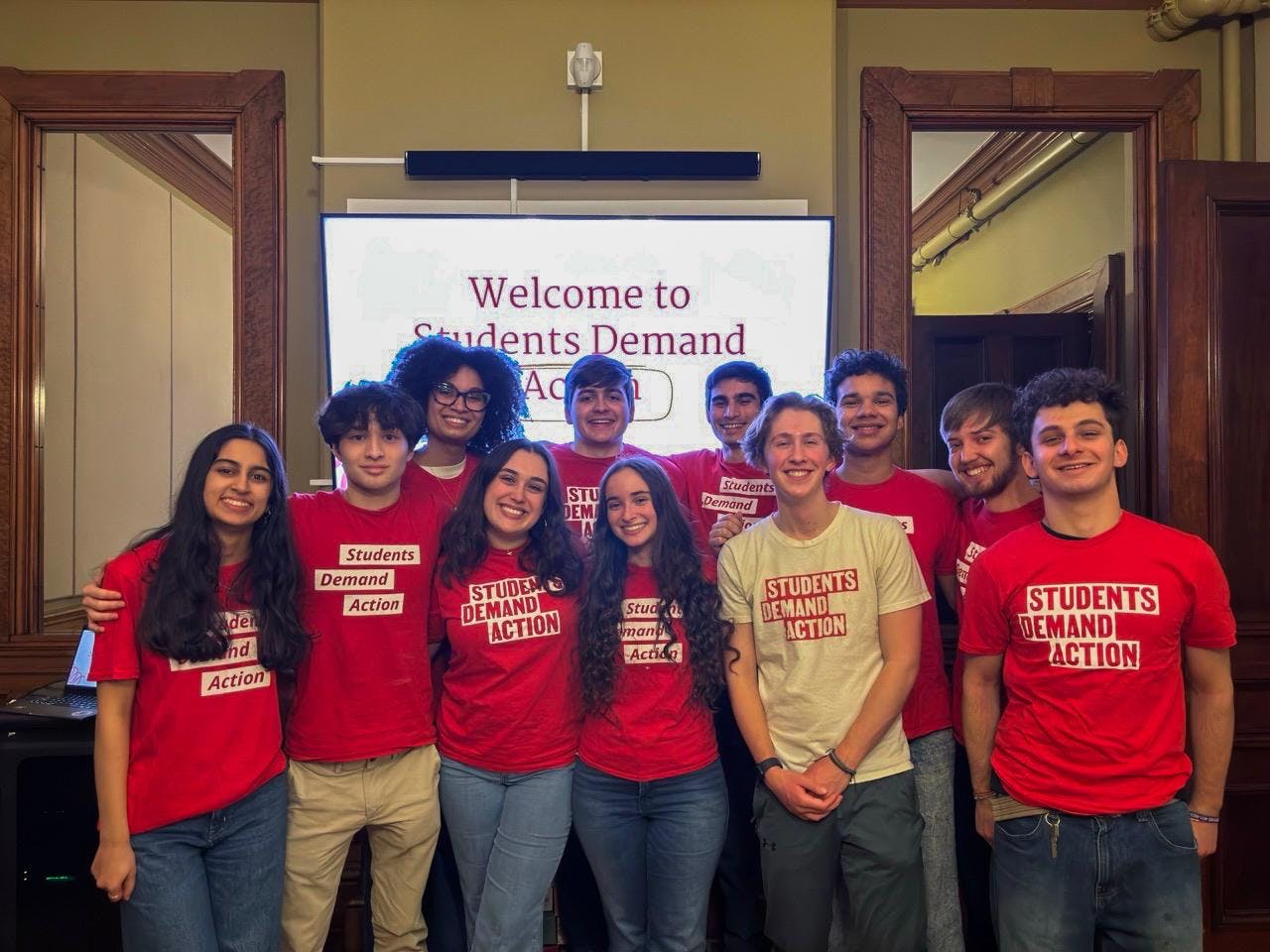A group photo of Brown advocacy organization Students Demand Action all wearing the red and white club t-shirts. 
