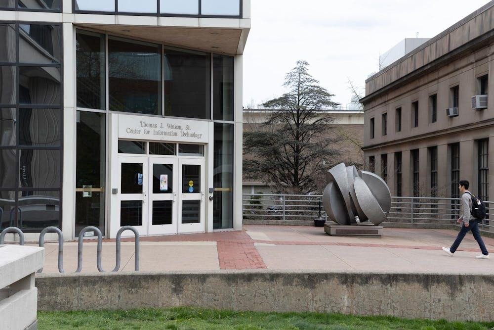 The Center of Information Technology with a student walking toward it.
