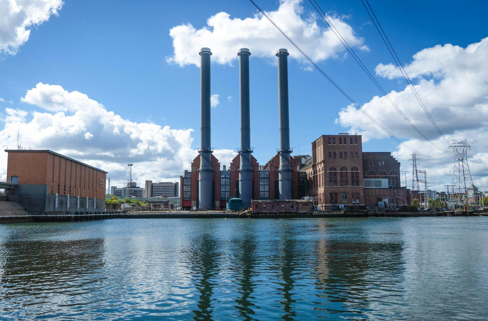 A photo of power plants overlooking a large body of water.