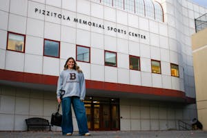 Photograph of Jessie Golden ’26 posing outside the Pizzitola Memorial Sports Center
