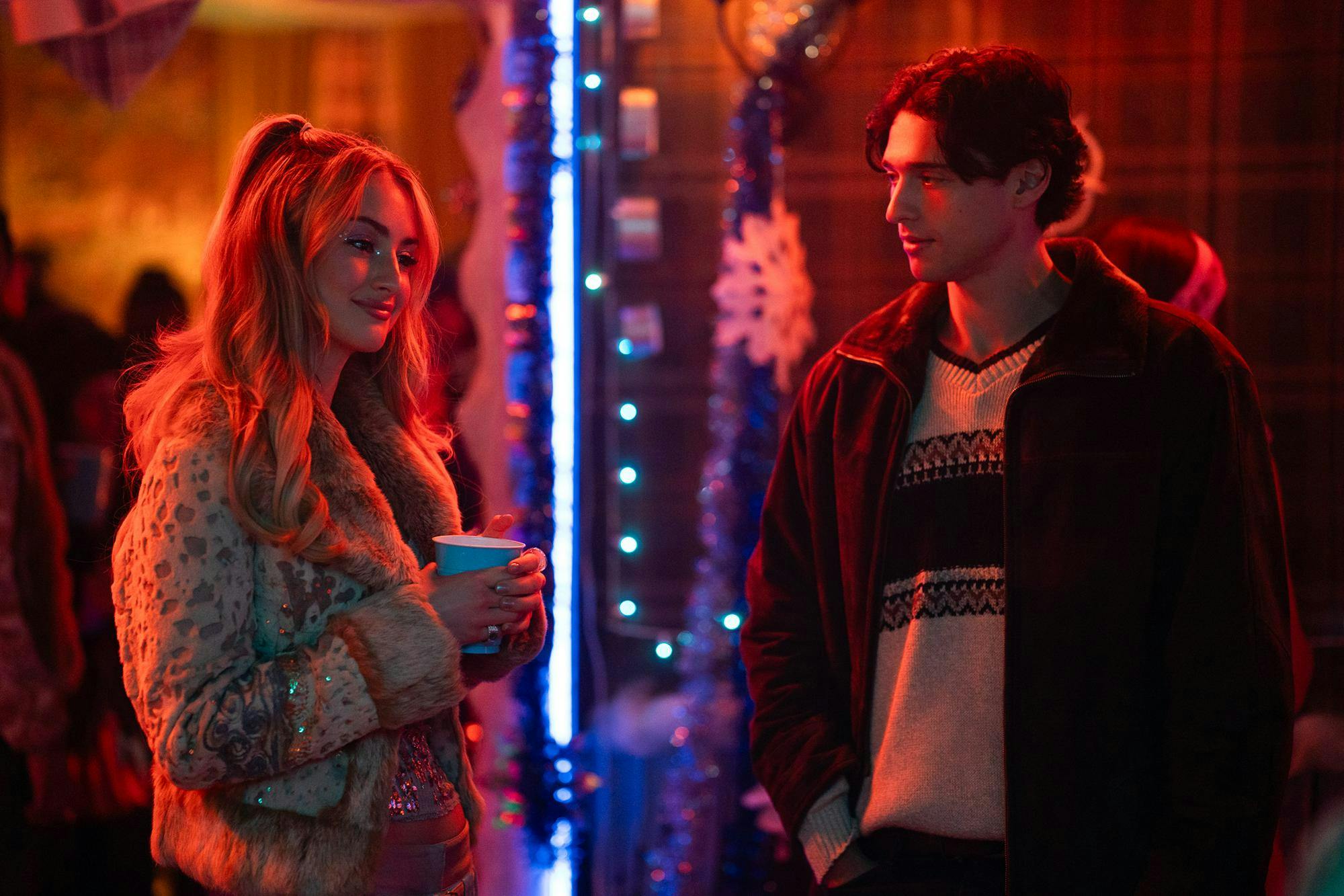 Photo from "Tell Me Lies" showing character Lucy Albright (Grace Van Patten) and Alex (Costa D'Angelo) in room with red lighting.