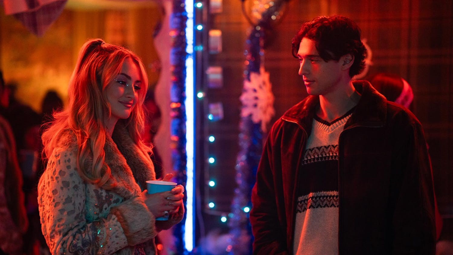 Photo from "Tell Me Lies" showing character Lucy Albright (Grace Van Patten) and Alex (Costa D'Angelo) in room with red lighting.