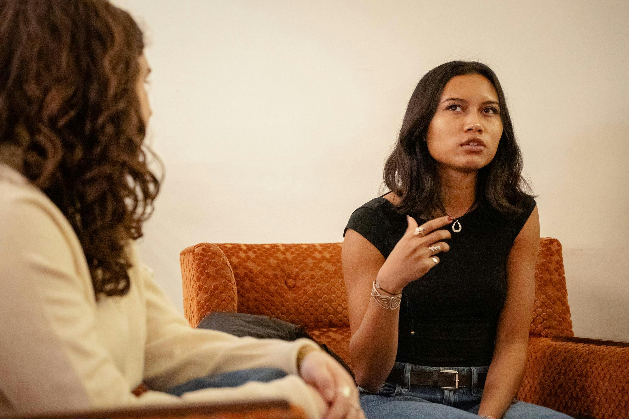 Teada Chhem ’27, in a black shirt and gold necklace, talking to Kayla Lerner ’27.