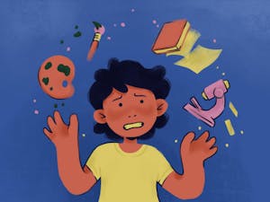 A student looking worried juggling a book, a paint brush, and a microscope.