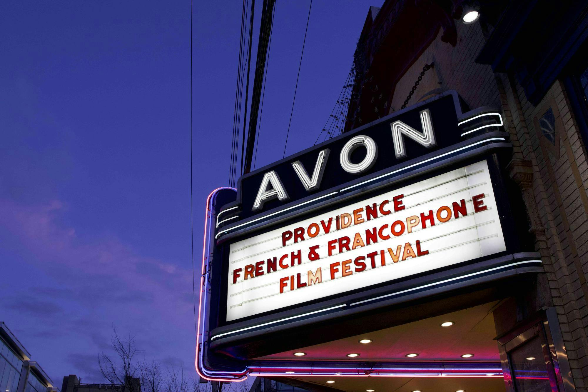 White sign displaying red letters reading 'Providence French & Francophone Film Festival.' 
