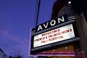 White sign displaying red letters reading 'Providence French & Francophone Film Festival.' 
