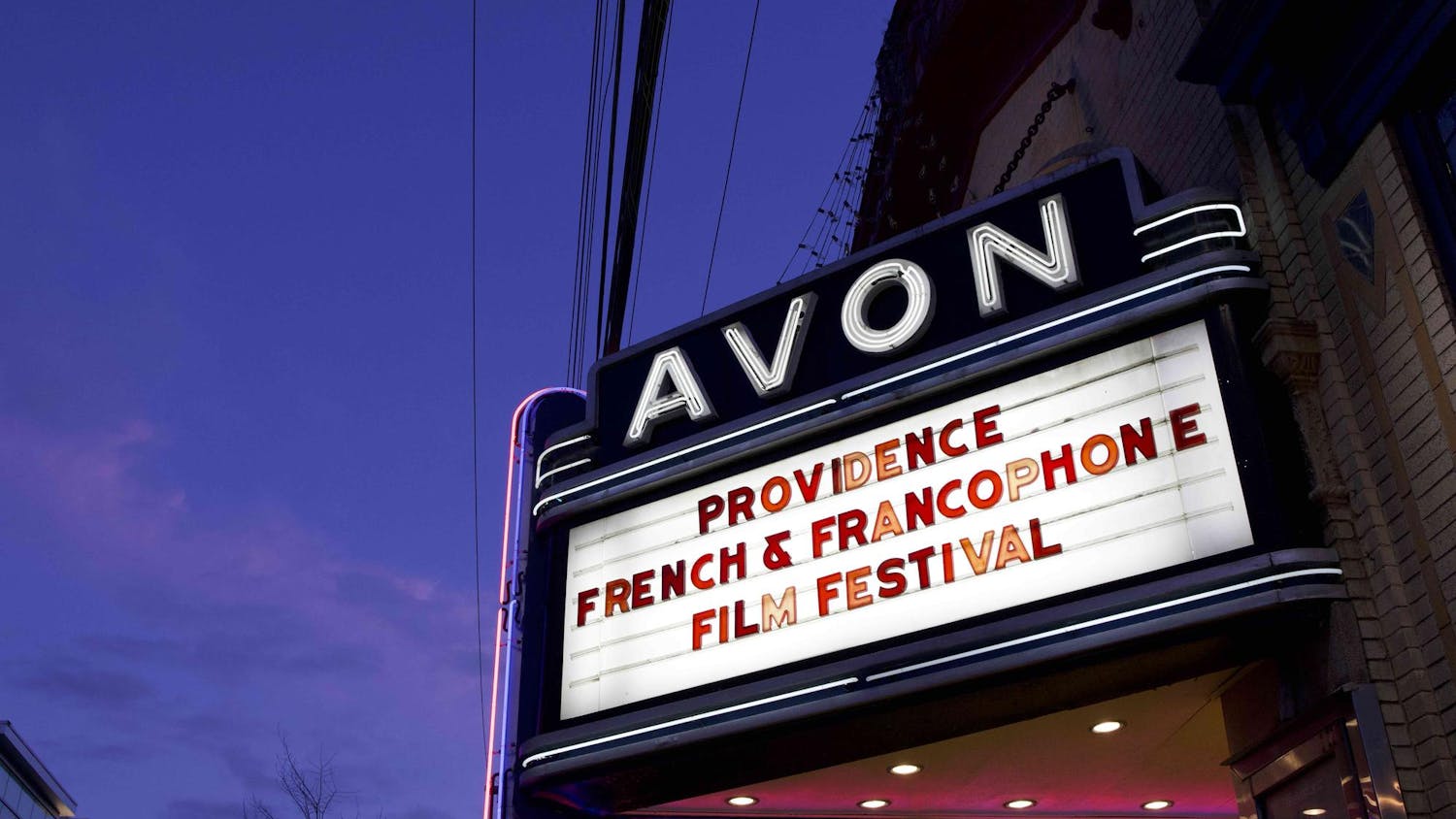 White sign displaying red letters reading 'Providence French & Francophone Film Festival.'
