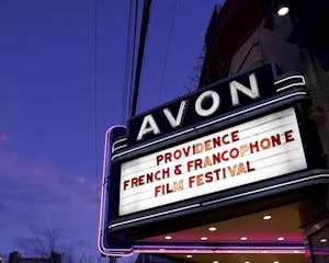 White sign displaying red letters reading 'Providence French & Francophone Film Festival.'