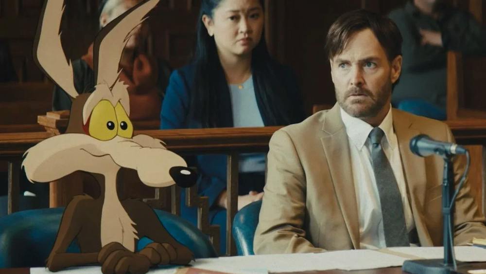 An image of cartoon Wile E. Coyote sitting next to his lawyer, Kevin Avery, played by Will Forte.