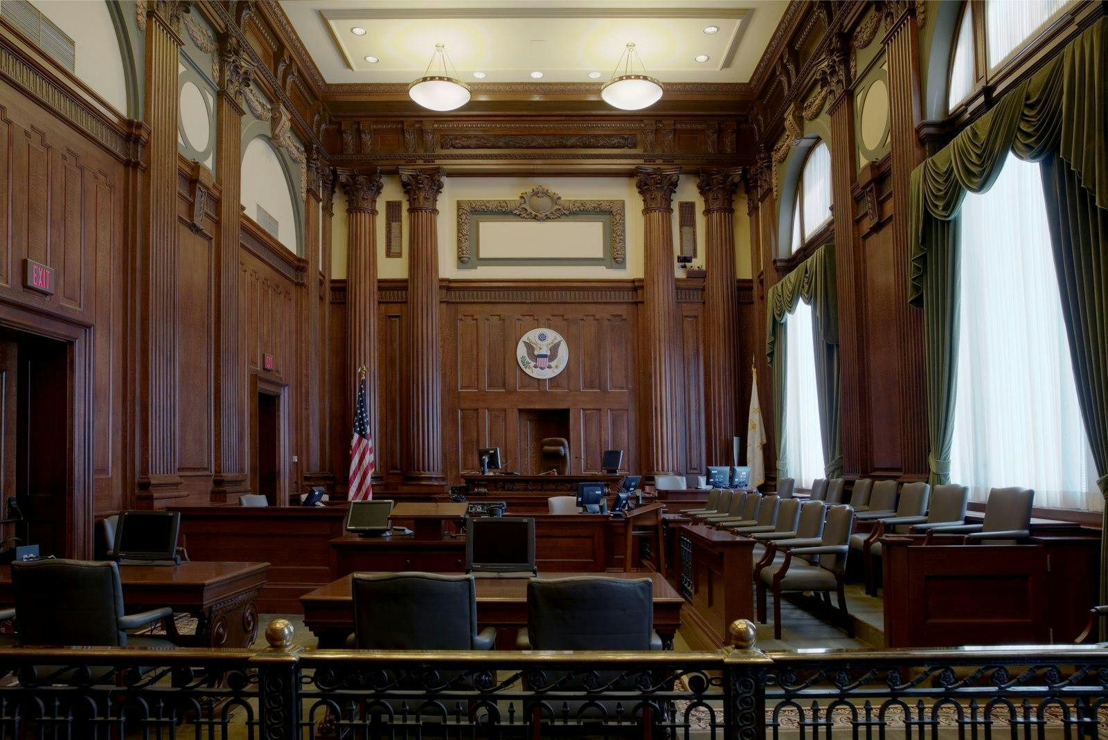The inside of the United States District Court for the District of Rhode Island, with an American flag against brown wood walls.